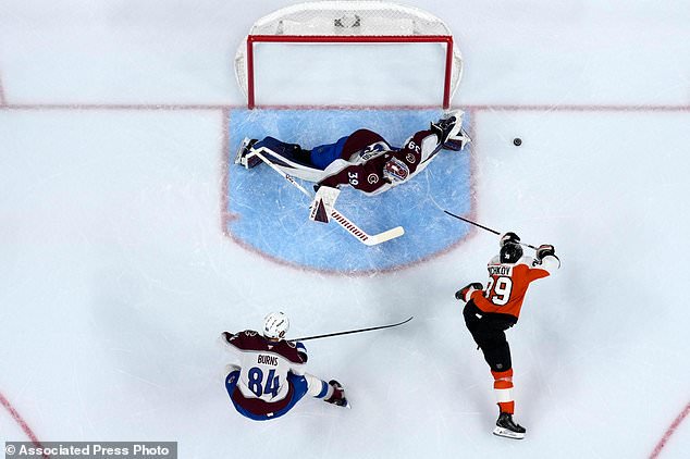 Philadelphia Flyers' Matvei Michkov (39) cannot get a shot past Colorado Avalanche's Mackenzie Blackwood (39) and Brent Burns (84) during the second period of an NHL hockey game Monday, Oct. 19, 2026, in Philadelphia. (AP Photo/Matt Slocum)