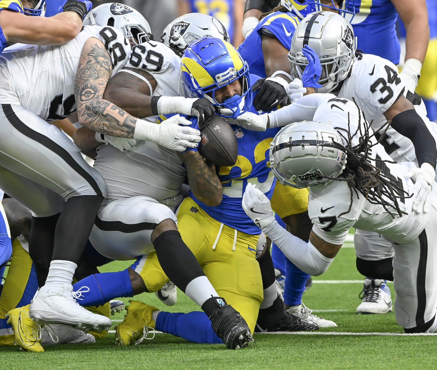 Oct 20, 2024; Inglewood, California, USA; Los Angeles Rams running back Kyren Williams (23) is gang tackled by Las Vegas Raiders defensive end Maxx Crosby (98), Adam Butler (69), Tre'von Moehrig (7) and Thomas Harper (34) at SoFi Stadium. Mandatory Credit: Robert Hanashiro-Imagn Images