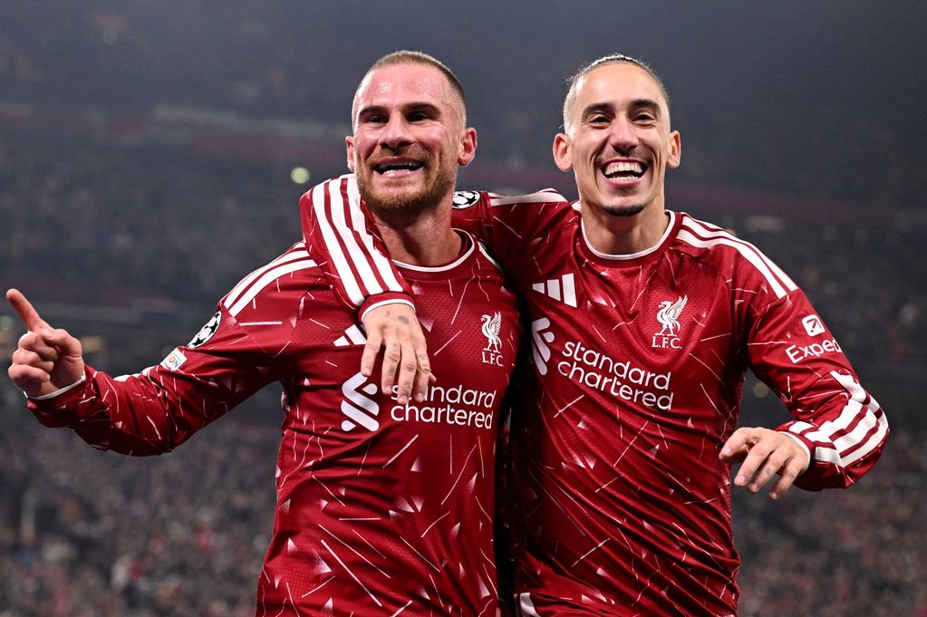 Alexis Mac Allister of Liverpool celebrates scoring his team’s third goal with teammate Kostas Tsimikas during the UEFA Champions League 2026/27 League Phase MD3 match between Liverpool FC and Villarreal CF at Anfield on October 20, 2026 in Liverpool, England