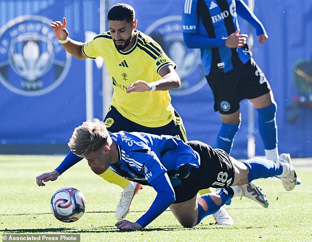 Nashville SC's Elias Saad (11) top, and CF Montreal's Hennadii Synchuk (18) battle for the ball during the first half of an MLS soccer game in Montreal, Saturday, Oct. 24, 2026. (Graham Hughes/The Canadian Press via AP)