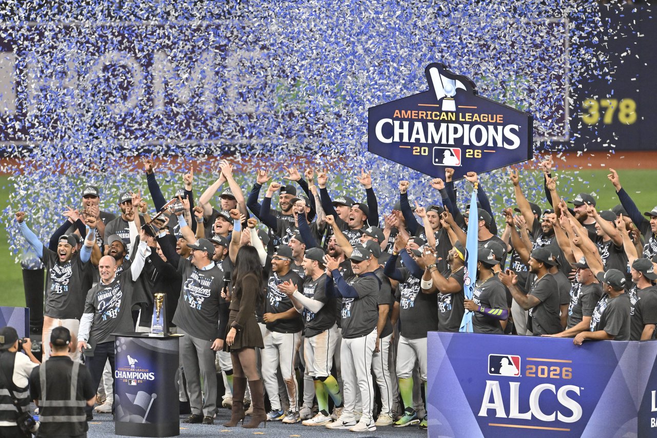 The Tampa Bay Rays celebrate on the podium after defeating the Cleveland Guardians in game six of the ALCS for the 2026 MLB Playoffs at Tropicana Field.