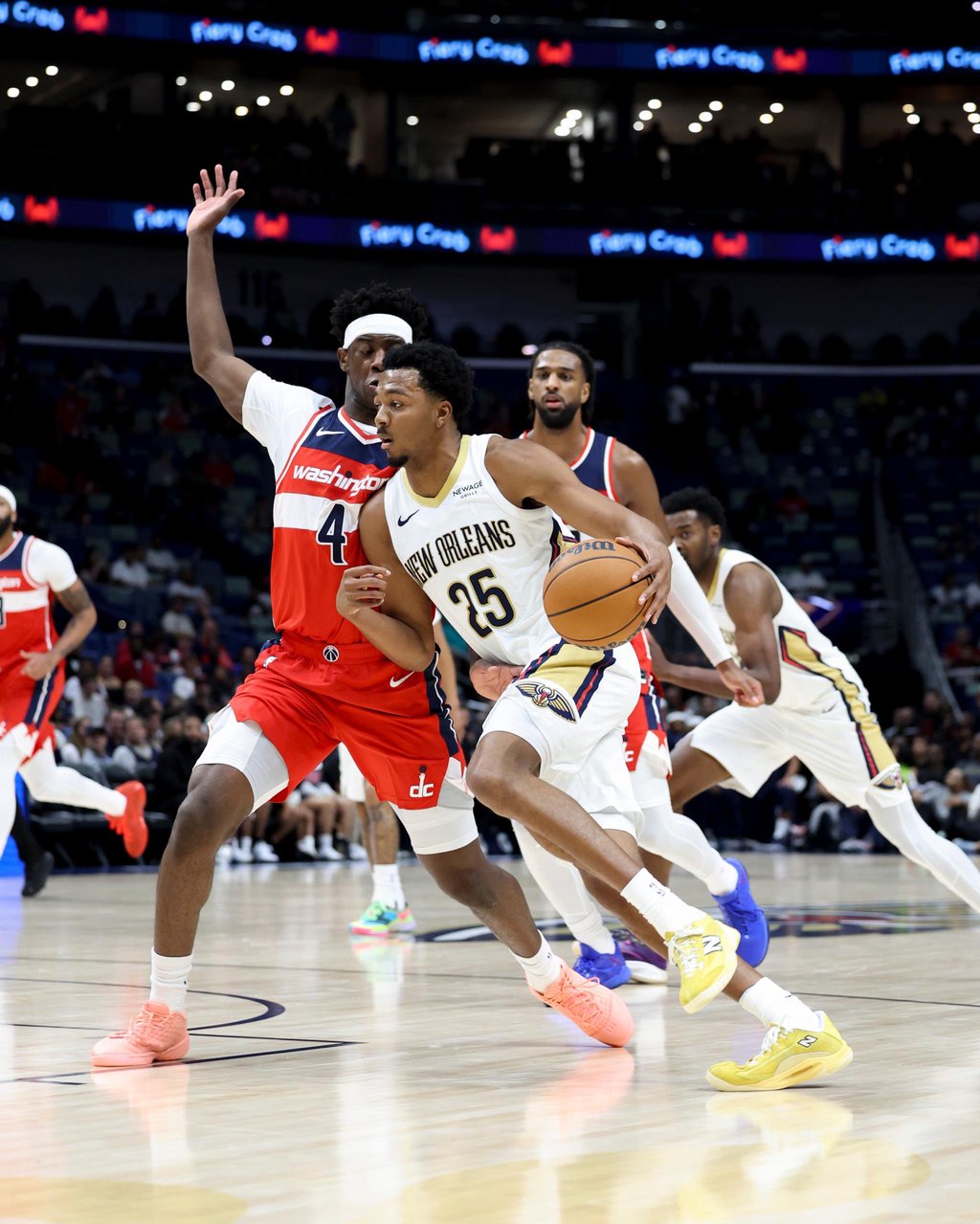 New Orleans Pelicans forward Trey Murphy III (25) drives past Washington Wizards forward AJ Dybantsa (4) during an NBA game.