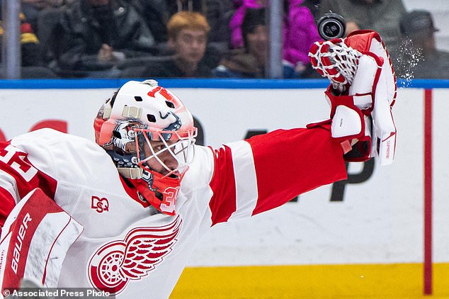 Detroit Red Wings goaltender Michal Postava (35) stops the puck against the Vancouver Canucks during the third period of an NHL hockey game in Vancouver, British Columbia, Thursday, Oct. 22, 2026. (Ethan Cairns/The Canadian Press via AP)