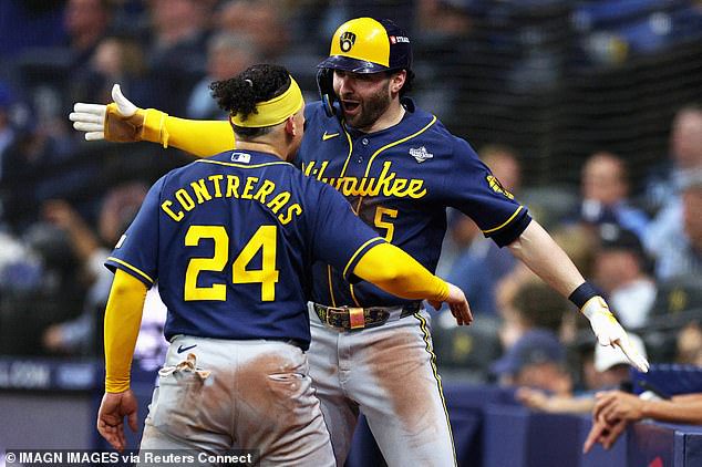 Brewers catcher William Contreras celebrates with outfielder Garrett Mitchell after scoring