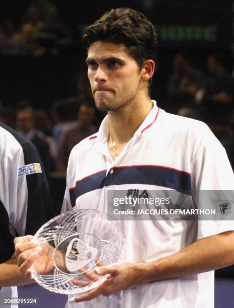 Australian mark philippoussis holds the second place trophy after losing the against