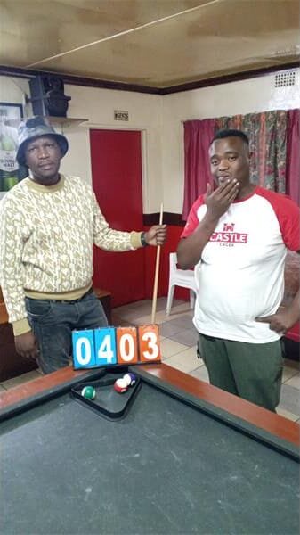 two men at a pool table