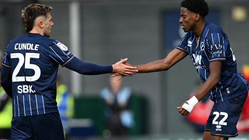 Kyrell Lisbie and (right) and Luke Cundle celebrate the former's goal