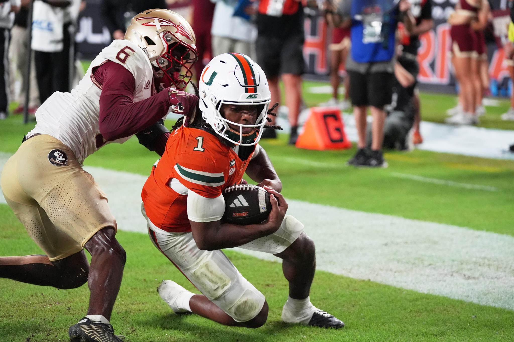 Miami wide receiver Malachi Toney (1) scores a touchdown past Florida State defensive back Ja'bril Rawls (6).