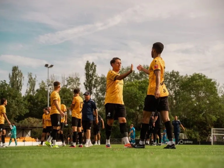 Real Bedford players giving each other high fives at the end of the game against Leamington in August 2026