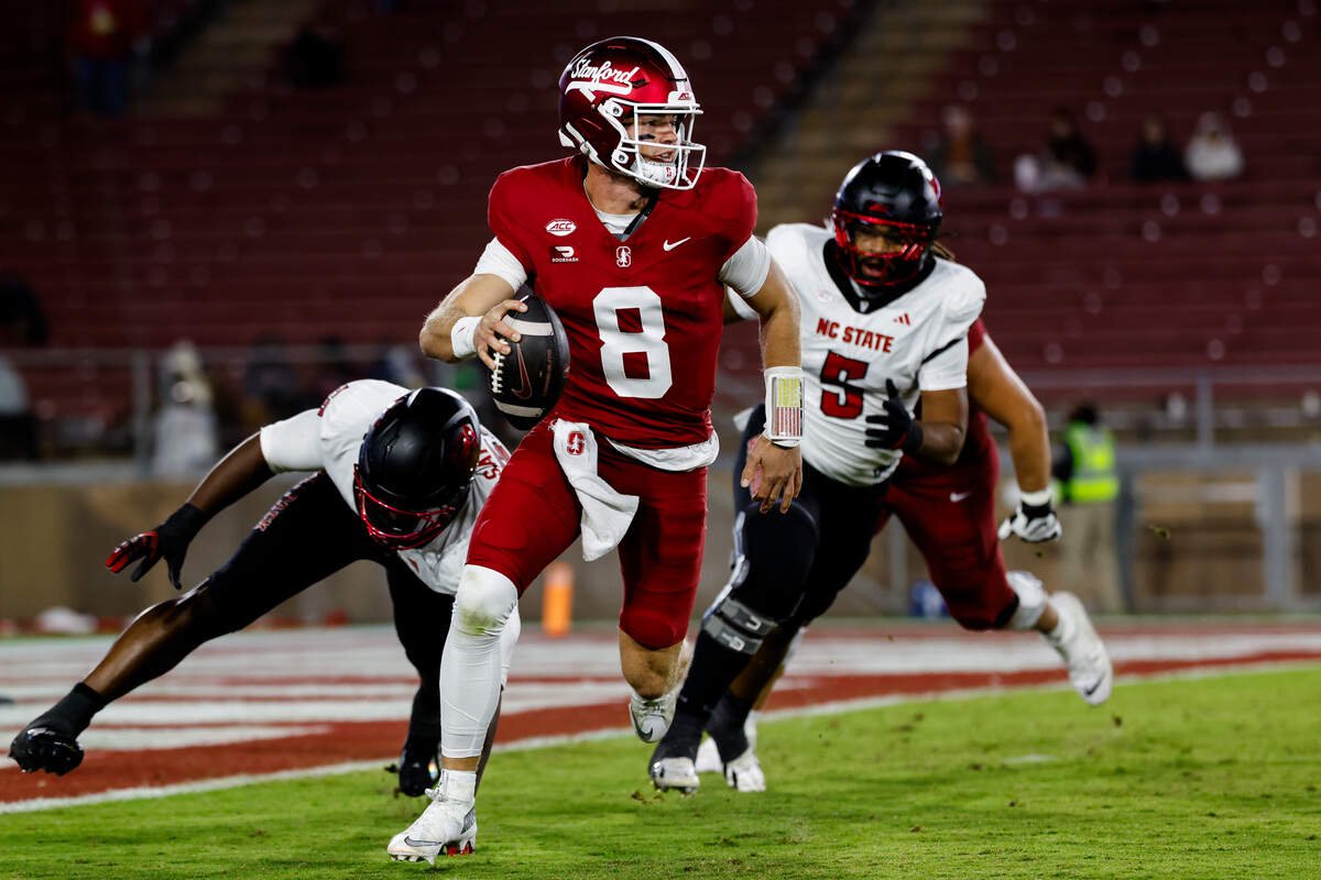 Oct 23, 2026; Stanford, California, USA;  Stanford Cardinal quarterback Davis Warren (8) avoids NC State Wolfpack linebacker Elijah Satchell (58) during the second quarter at Stanford Stadium.  Mandatory Credit: Sergio Estrada-Imagn Images