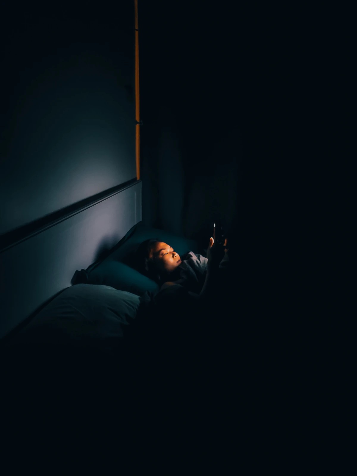 woman on phone in bed
