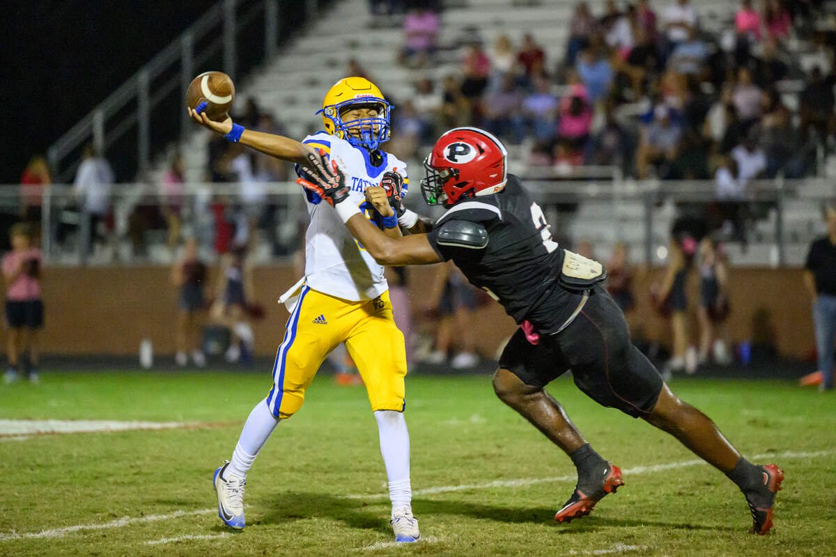 Tattnall quarterback Angelo Bellamy Jr. passes under pressure from an FPD defender Friday night.