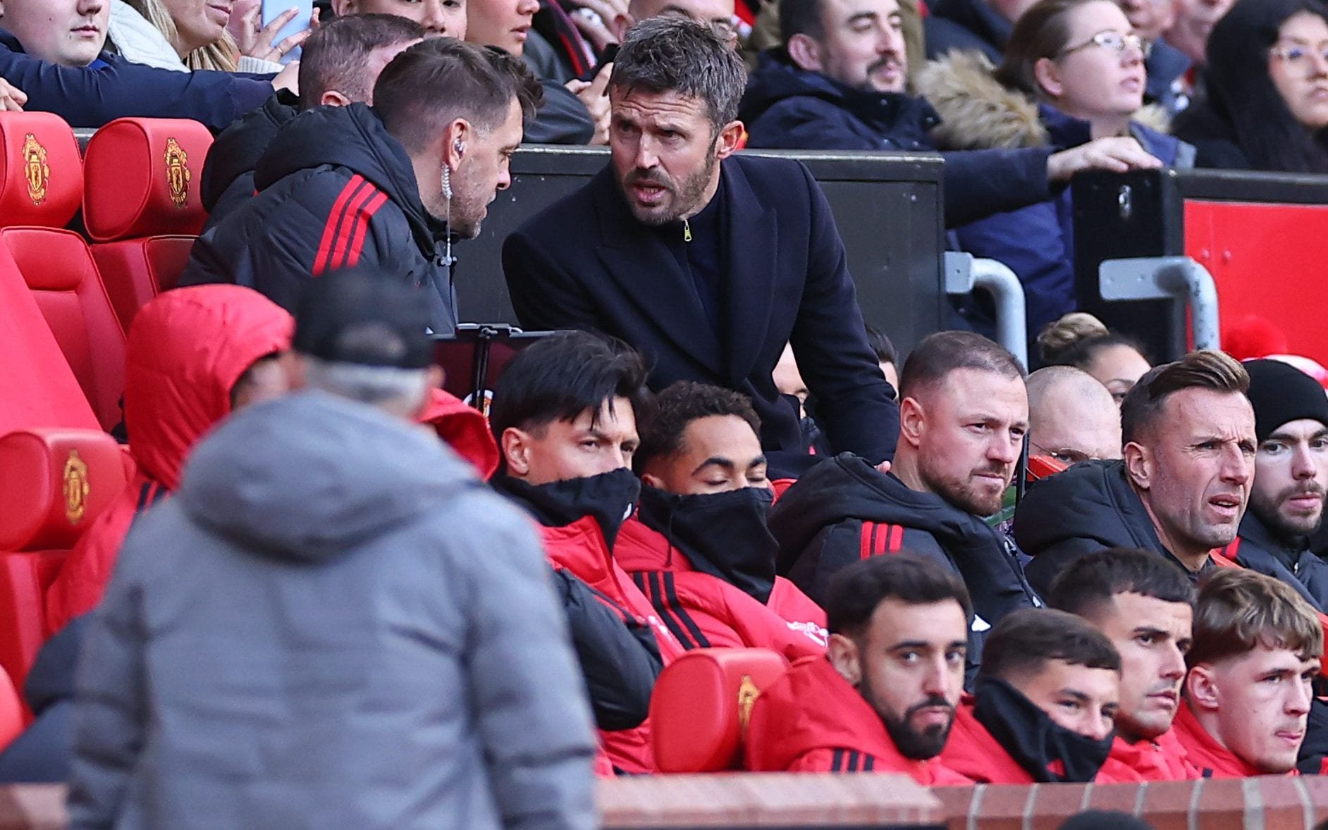 Michael Carrick and Bruno Fernandes watch from the dugout