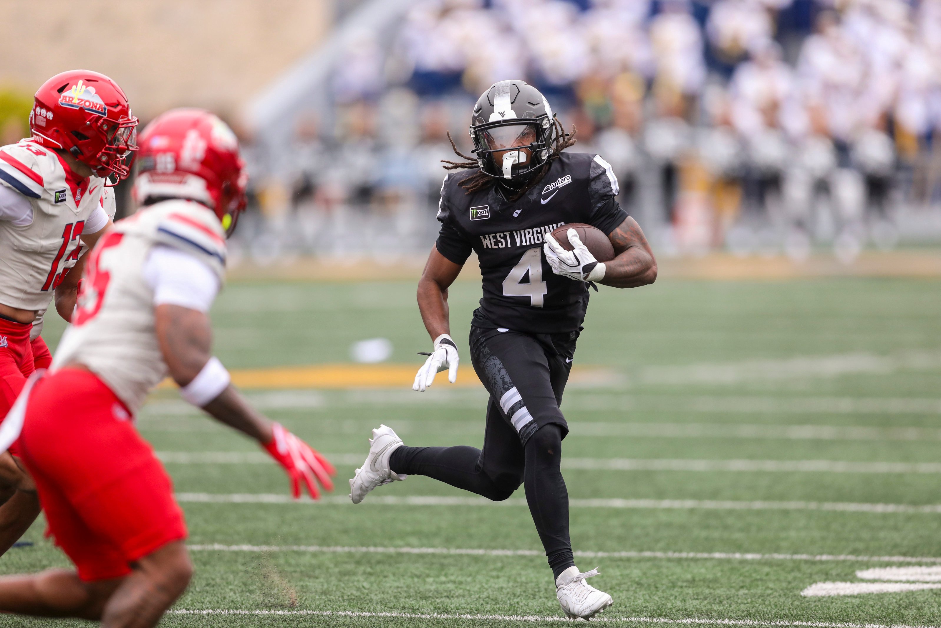 Oct 10, 2026; Morgantown, West Virginia, USA; West Virginia Mountaineers running back Cam Cook (4) runs the ball during the third quarter against the Arizona Wildcats at Milan Puskar Stadium. Mandatory Credit: Ben Queen-Imagn Images
