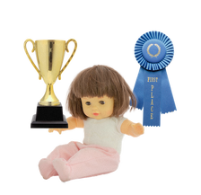 a doll with a couple of trophies