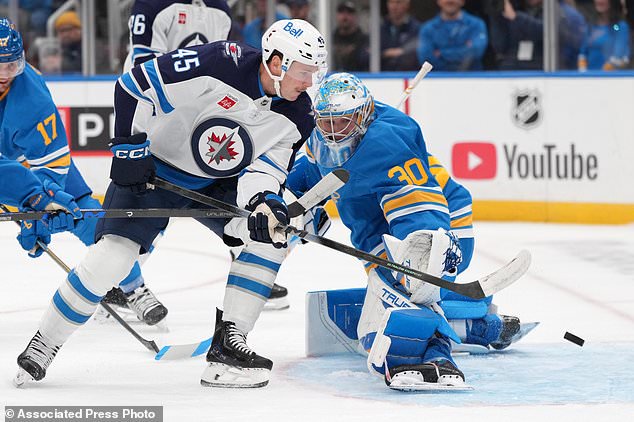 Winnipeg Jets' Cole Koepke (45) is unable to score past St. Louis Blues goaltender Joel Hofer (30) during the first period of an NHL hockey game Tuesday, Oct. 20, 2026, in St. Louis. (AP Photo/Jeff Roberson)