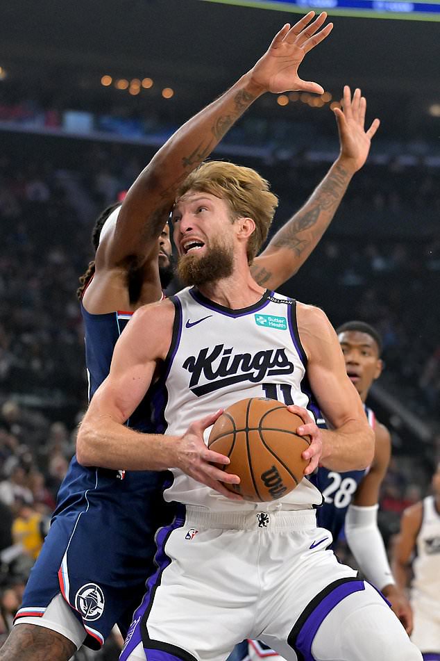 Sacramento Kings center Domantas Sabonis (11) is defended by Los Angeles Clippers forward Isaiah Jackson during the first half of an NBA basketball game Wednesday, Oct. 21, 2026, in Los Angeles. (AP Photo/Jayne Kamin-Oncea)