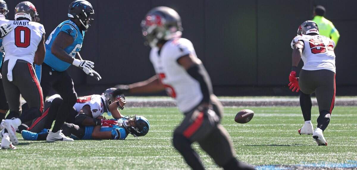 Carolina Panthers quarterback Bryce Young, center fumbles the ball as he is sacked by Tampa Bay Buccaneers defender during action at Bank of America Stadium in Charlotte, NC on Sunday, October 25, 2026. At right Buccaneers defensive lineman Calijah Kancey chases the ball to recover and score a touchdown on the play.