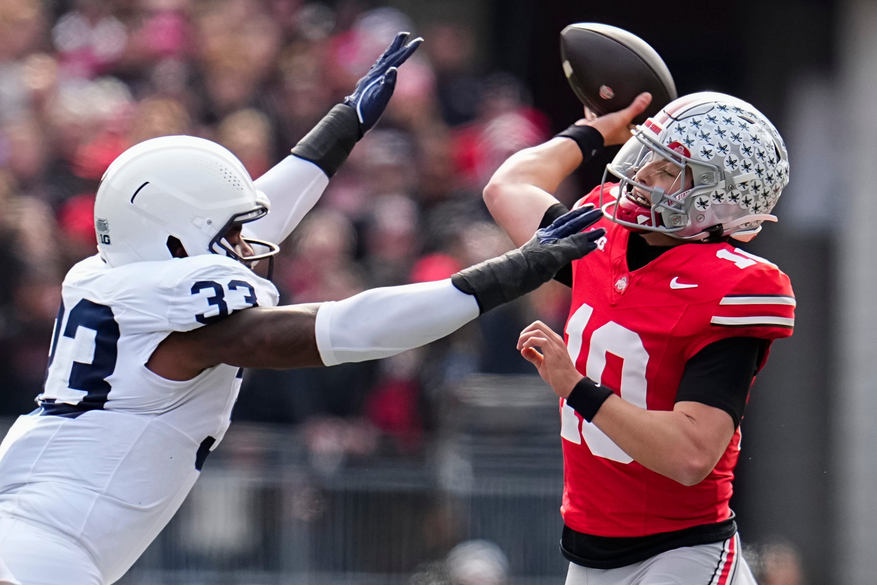 Ohio State Buckeyes quarterback Julian Sayin (10) throws under pressure from Penn State Nittany Lions defensive end Dani Dennis-Sutton (33) during the NCAA football game at Ohio Stadium in Columbus on Nov. 1, 2025.