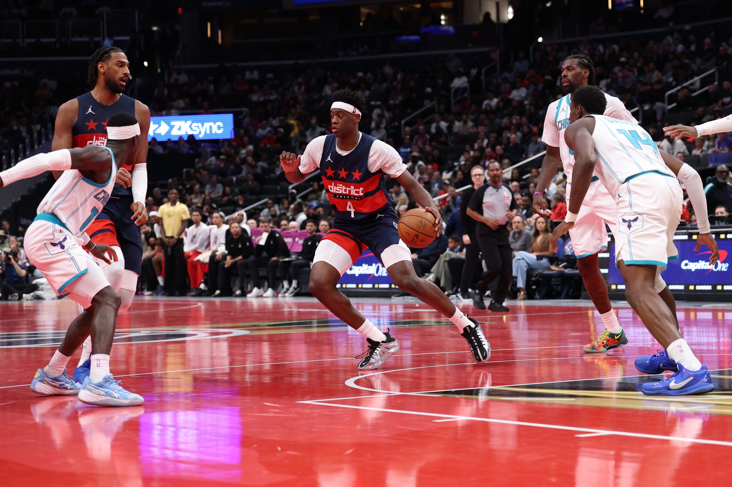 Oct 30, 2026; Washington, District of Columbia, USA; Washington Wizards forward AJ Dybantsa (4) dribbles the ball as Charlotte Hornets guard Dennis Schroder (17) and Hornets forward Moussa Diabate (14) defend in the second half in an NBA Cup game at Capital One Arena. Mandatory Credit: Geoff Burke-Imagn Images