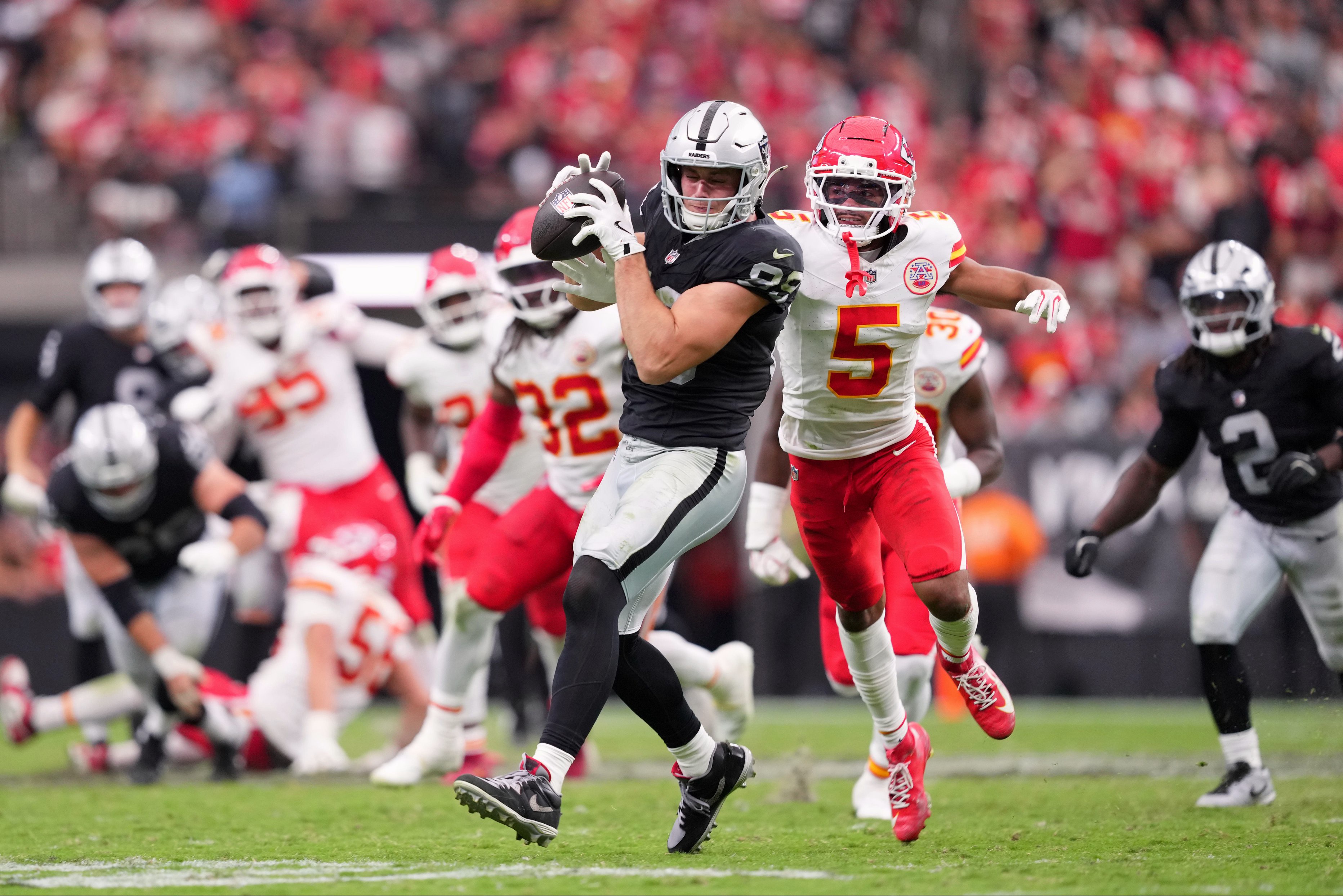 Oct 4, 2026; Paradise, Nevada, USA;  Las Vegas Raiders tight end Brock Bowers (89) runs after a catch against Kansas City Chiefs cornerback Mansoor Delane (5) during the fourth quarter at Allegiant Stadium.  Mandatory Credit: Joe Camporeale-Imagn Images