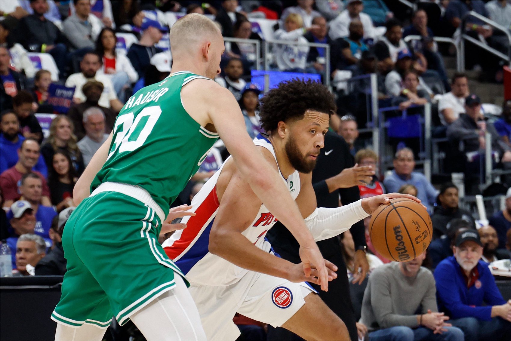 Oct 20, 2026; Detroit, Michigan, USA;  Detroit Pistons guard Cade Cunningham (2) dribbles defended by Boston Celtics forward Sam Hauser (30) in the first half at Little Caesars Arena.  Mandatory Credit: Rick Osentoski-Imagn Images