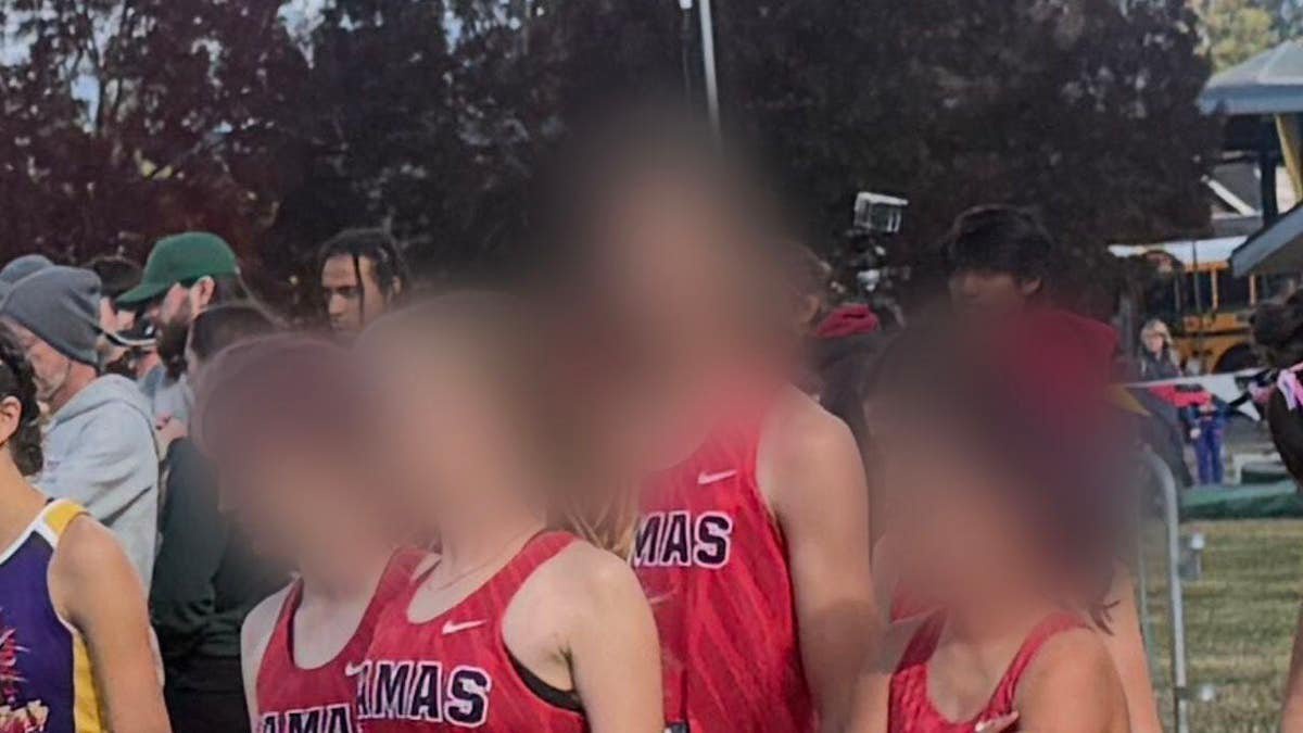 A Camas High cross country runner, who switched from the boys team to the girls team midseason, stands at the start line of a girls race in at the Nike Hole in the Wall XC Invitational.
