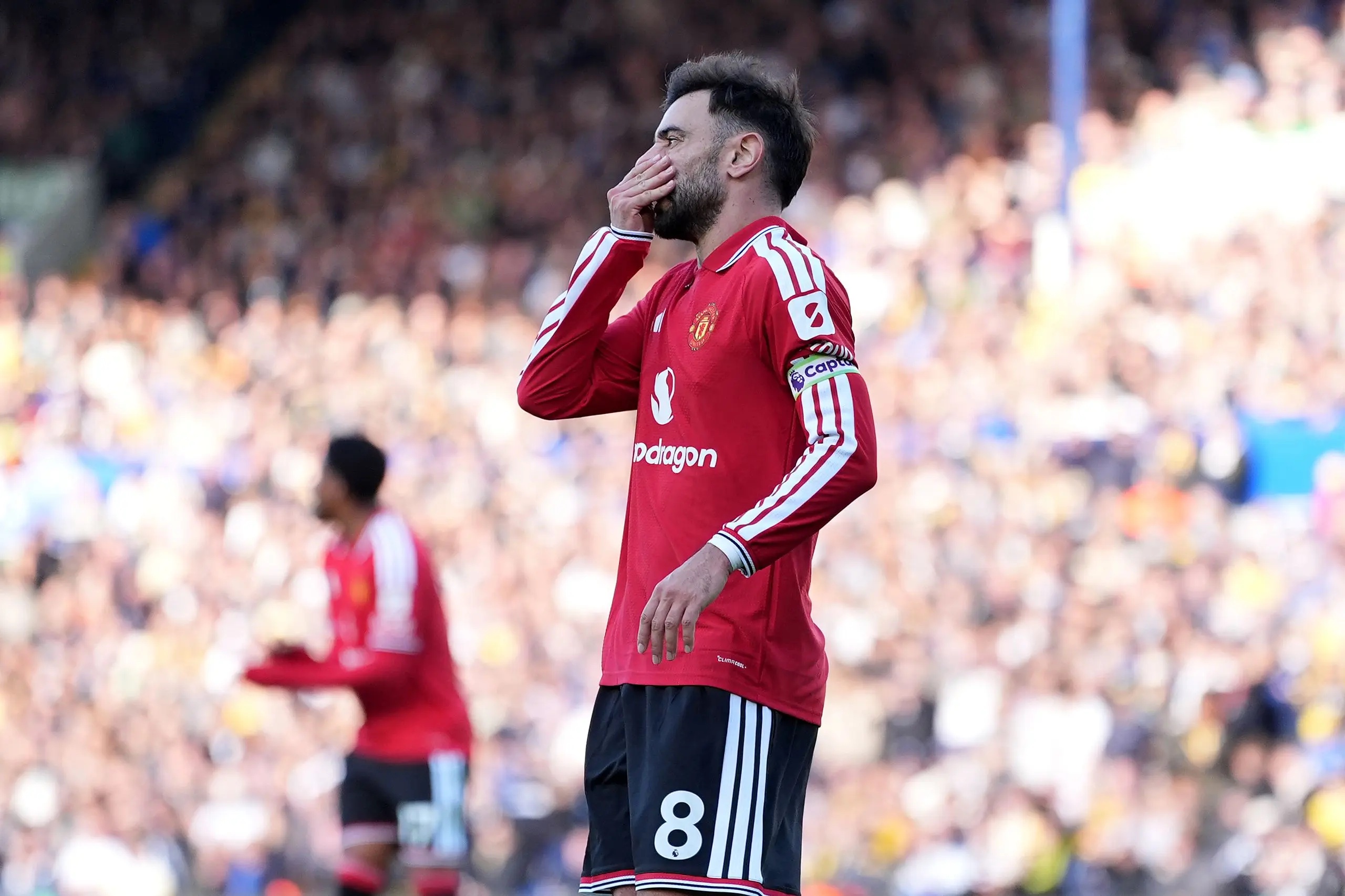 Bruno Fernandes covering his mouth.