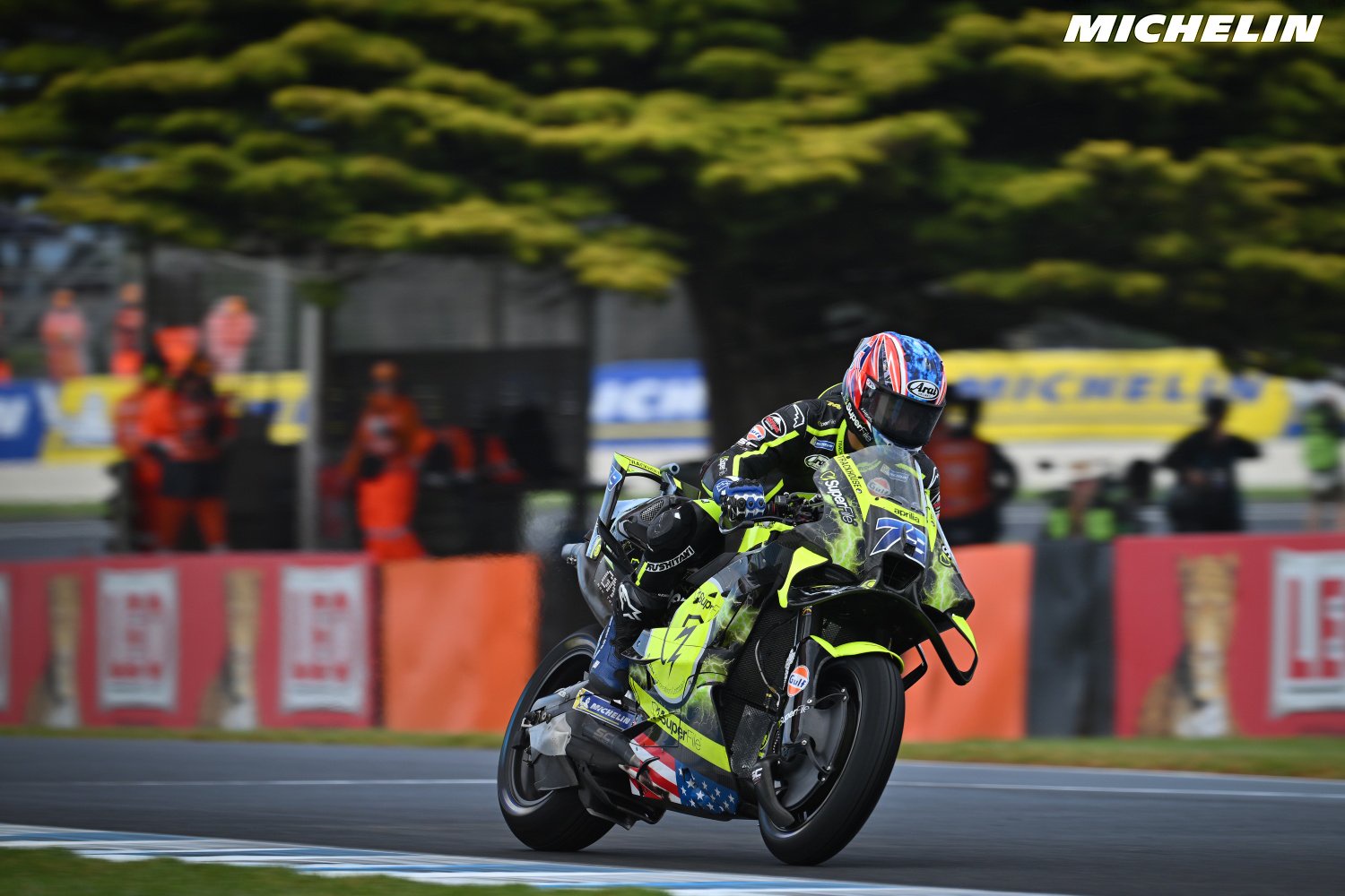 Ai Ogura riding his yellow and black Trackhouse MotoGP bike on a wet-looking track at the Australian Grand Prix