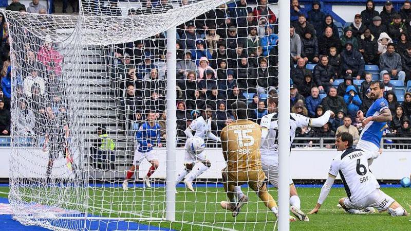 Millwall's Lyndon Dykes scores an own goal against Portsmouth at Fratton Park