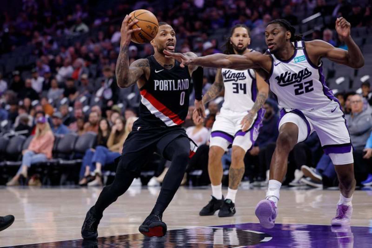 Oct 13, 2026; Sacramento, California, USA; Portland Trail Blazers guard Damian Lillard (0) drives in against Sacramento Kings forward Jonathan Mogbo (22) during the second quarter at Golden 1 Center. © Kelley L Cox-Imagn Images