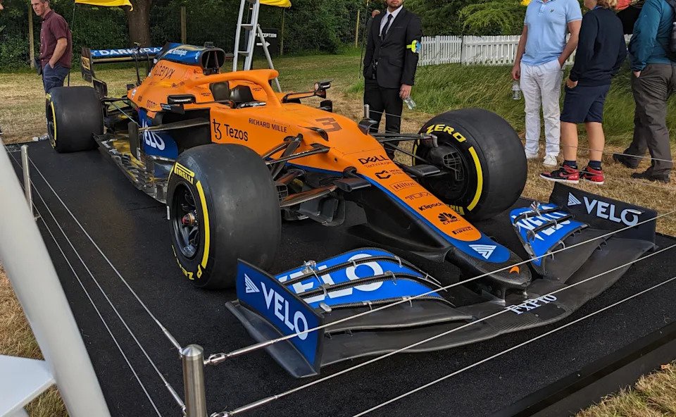 Orange McLaren MCL35M Formula 1 car on a display plinth