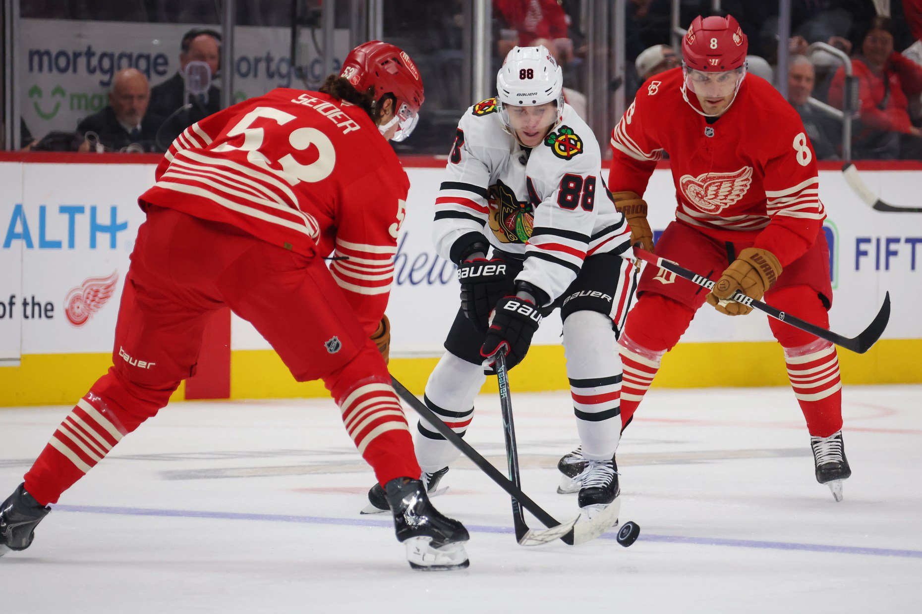 Blackhawks right wing Patrick Kane (88) battles for the puck with the Red Wings' Moritz Seider, left, during the first period at Little Caesars Arena on Thursday, Oct. 29, 2026, in Detroit. (Gregory Shamus/Getty)
