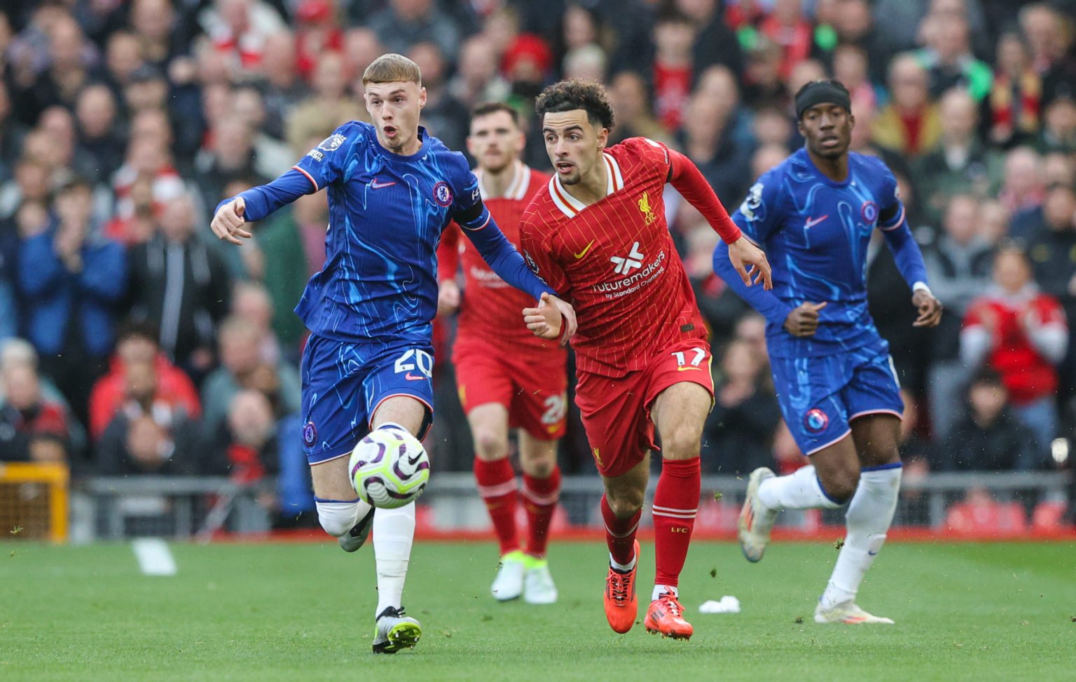 Liverpool's Curtis Jones battles with Chelsea's Cole Palmer during the Premier League match between Liverpool FC and Chelsea FC at Anfield on Octob...