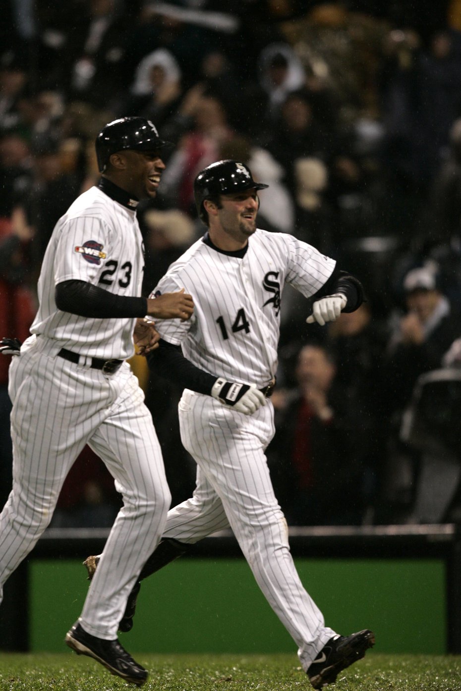 Paul Konerko (14) heads to the dugout with teammate Jermaine Dye (23) after hitting a grand slam in the seventh inning during Game 2 of the World Series against the Houston Astros on Oct. 23, 2005, at U.S. Cellular Field in Chicago. (Scott Strazzante/Chicago Tribune)