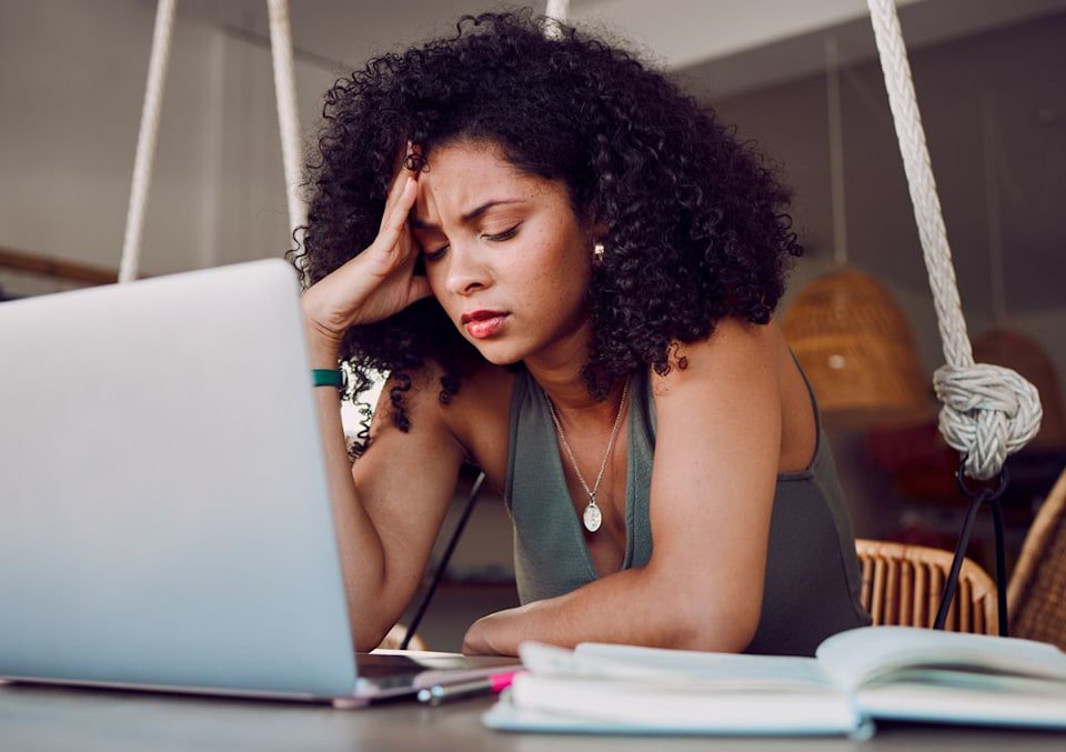 Woman looking tired on her computer