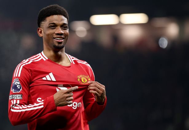 Amad points to the Manchester United badge on his shirt after scoring.