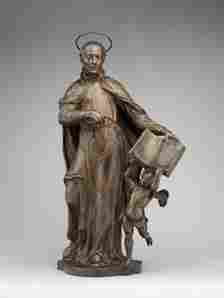 A statue of Saint Ignatius Loyola with an angel holding a book.