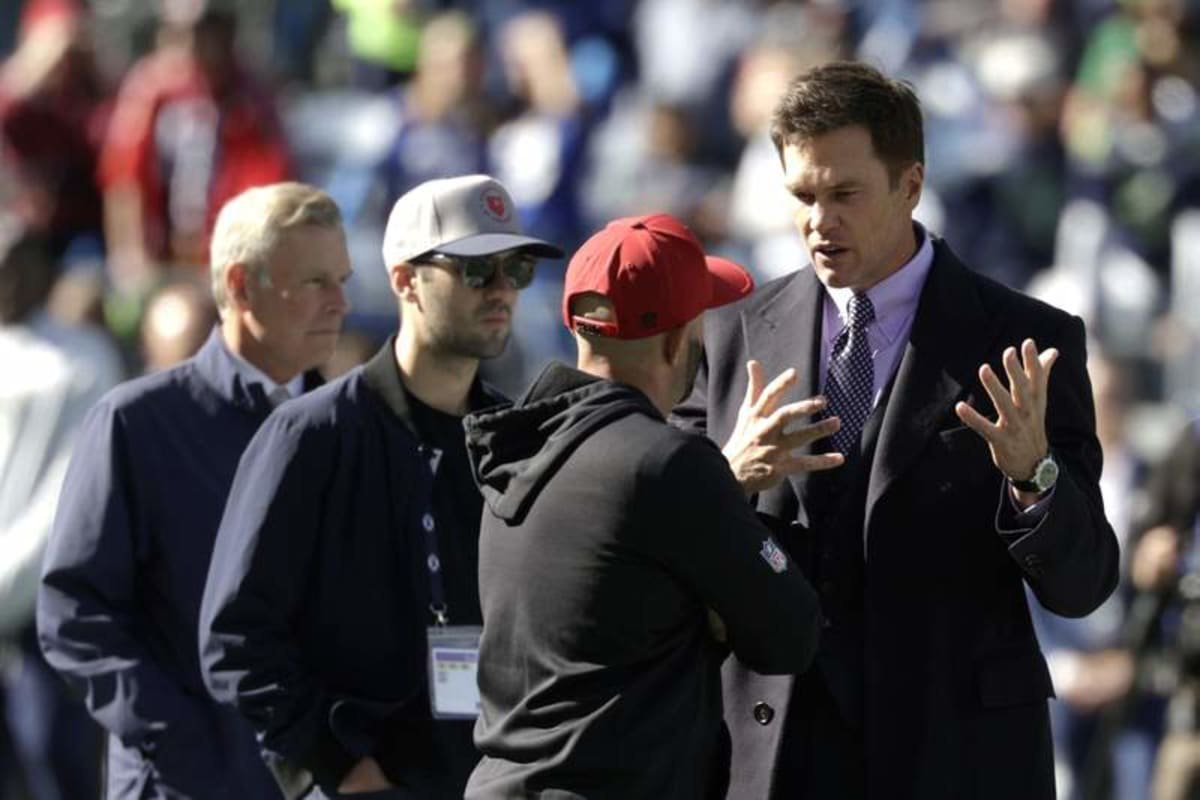 Oct 11, 2026; Seattle, Washington, USA; FOX Sports lead NFL analyst Tom Brady chats on the field before a game between the San Francisco 49ers and the Seattle Seahawks at Lumen Field. © Joe Nicholson-Imagn Images