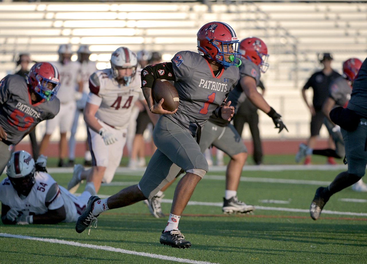 Old Mill Patriots quarterback Braylon Tucker #1 finds the edge for a nice run in the first quarter. The Old Mill Patriots host the visiting Broadneck Bruins in high school football at the Severn Run High School. (Paul W. Gillespie/Staff)