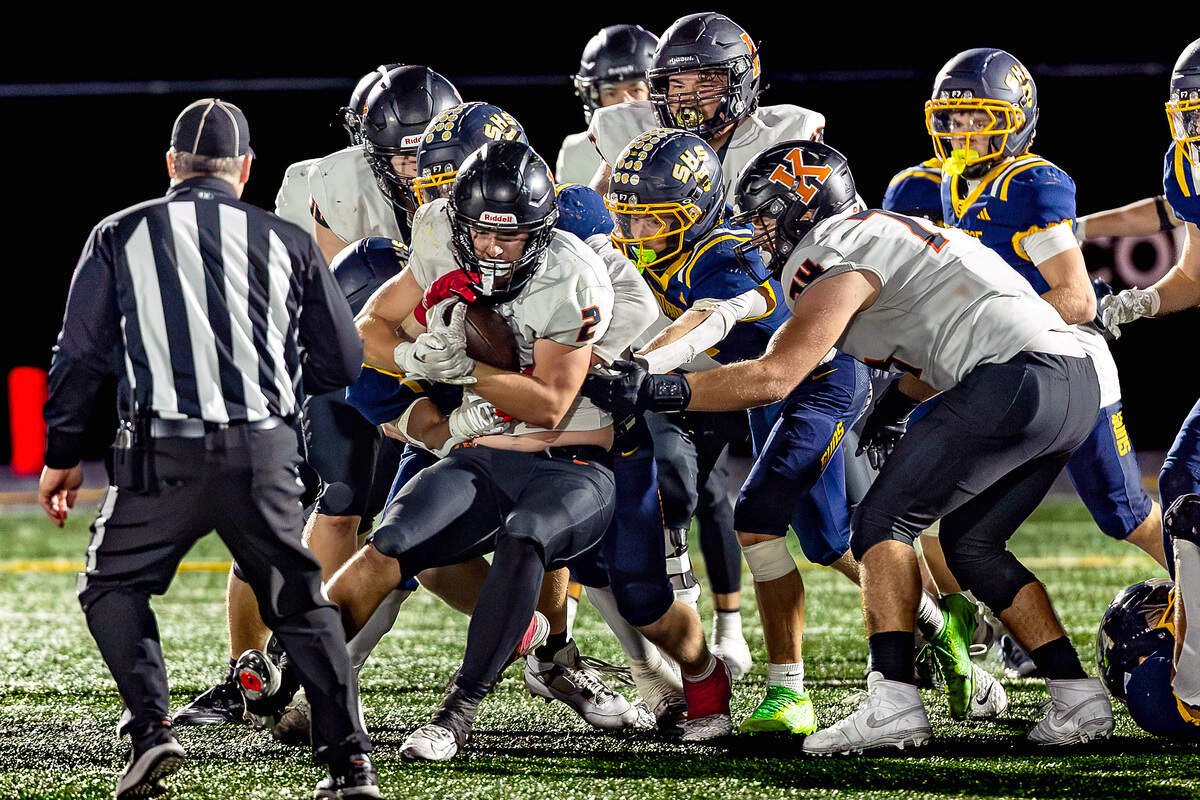 Southridge defenders converge on Kennewick's Jax Wright (2), stopping his forward progress during the Suns' game against the Lions on Thursday at Neil F. Lampson Stadium in Kennewick.