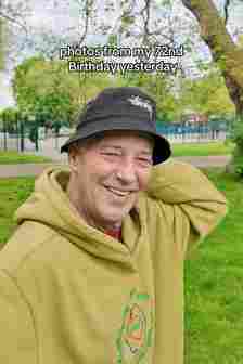 Michael Barrymore in a park wearing a bucket hat