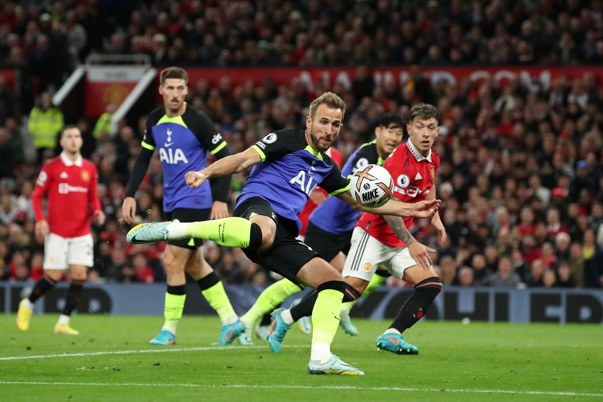 Harry Kane of Tottenham Hotspur shoots during the Premier League match between Manchester United and Tottenham Hotspur at Old Trafford on October 19, 2022 in Manchester, England