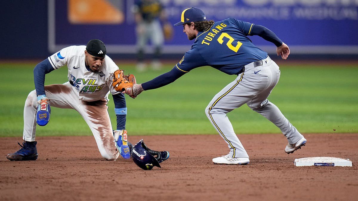 Chandler Simpson is tagged out by Brice Turang during a steal attempt in the World Series.