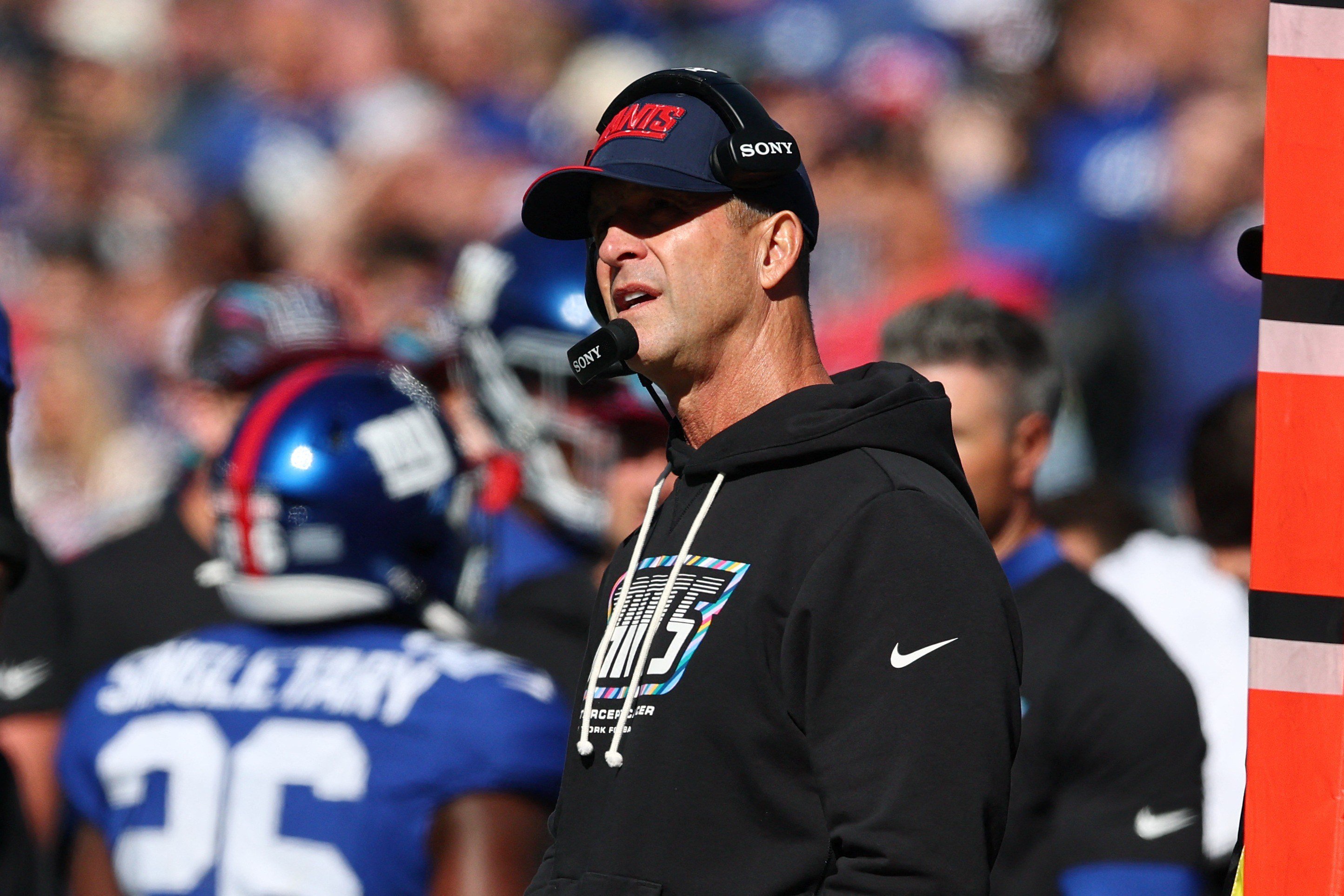 New York Giants head coach John Harbaugh watches game play against the New Orleans Saints.