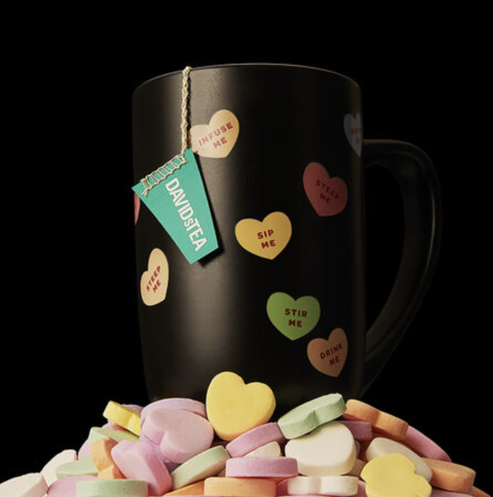 the mug sitting on top of a pile of candy hearts