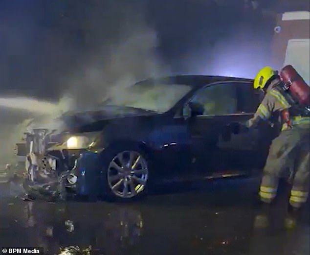 Moment two men pour petrol over car at family home of a politician and then set it ablaze (Video)