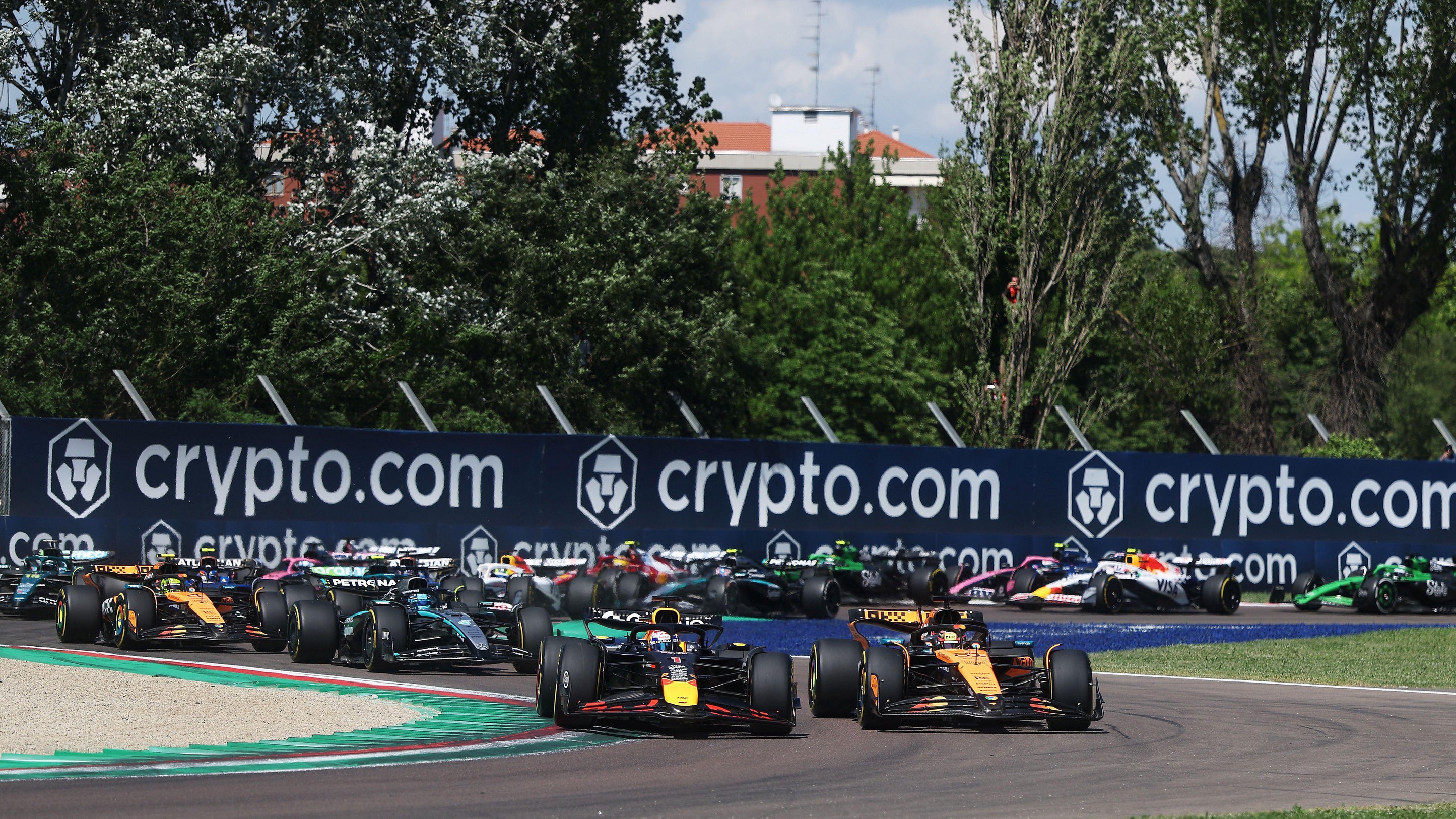 Red Bull's Max Verstappen passes McLaren's Oscar Piastri to take the lead at the first corner of the 2025 Emilia-Romagna Grand Prix