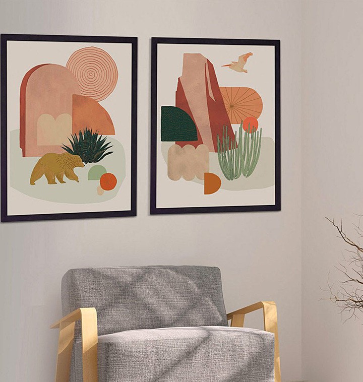 the pair of prints framed and hanging over a chair