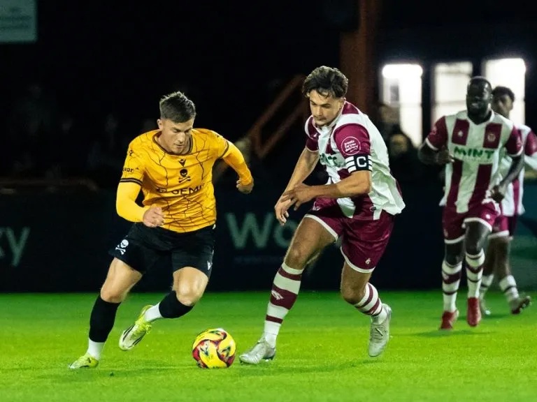 Real Bedford's Josh Allen takes the ball past a Stourbridge defender at the Ledger Stadium